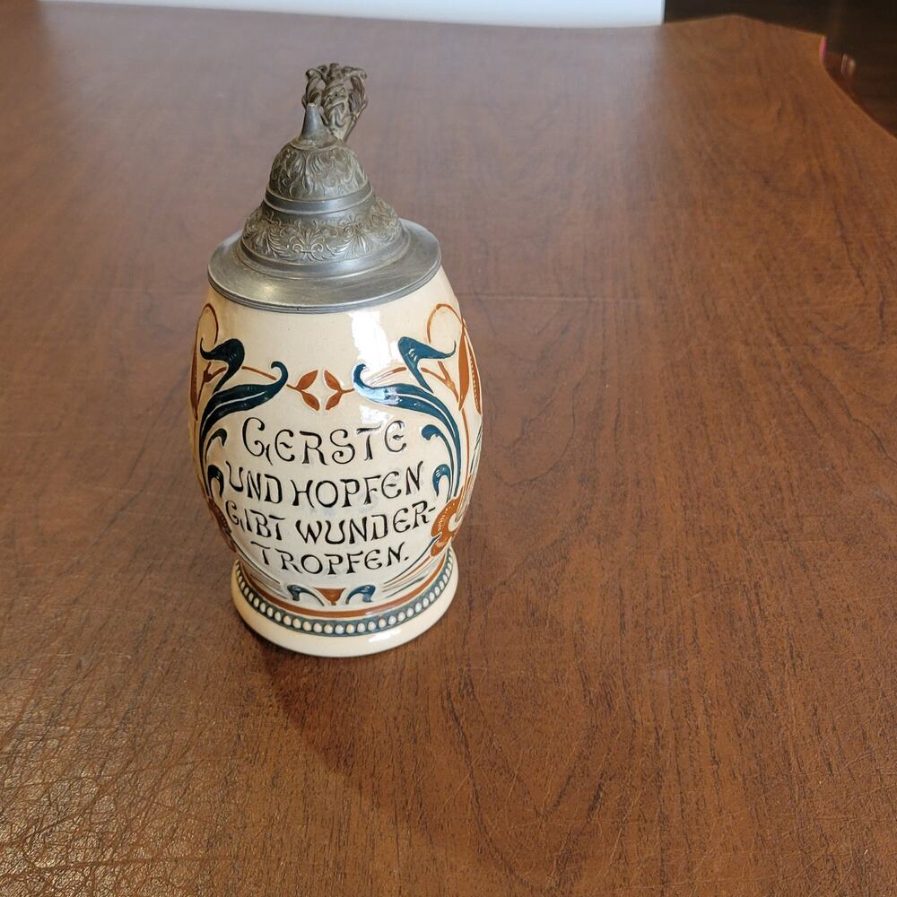 Vintage traditional German ceramic beer stein with pewter lid.